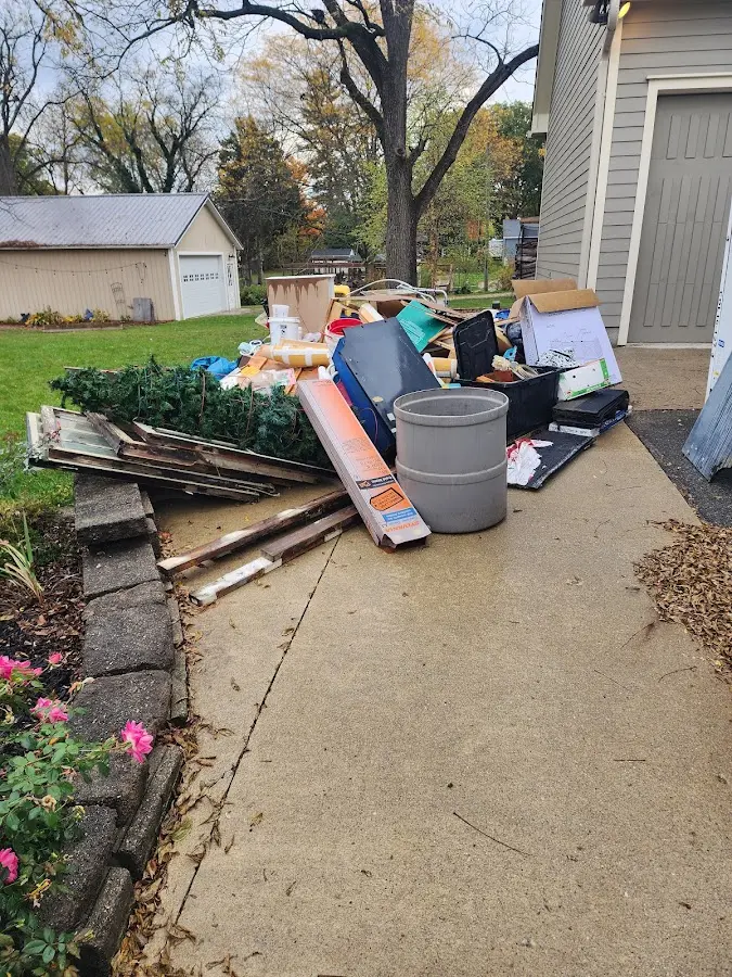 Dumpster being loaded with debris for 12 Yard Dumpster Rental in Spring City